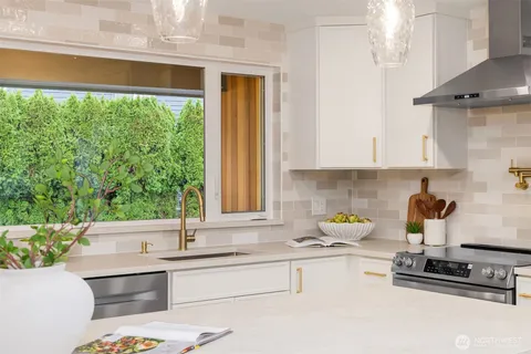 a kitchen with a sink and a stove top oven