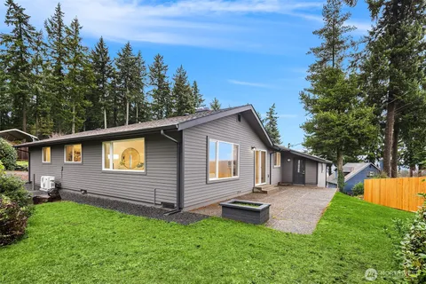 a view of a house with a yard and deck