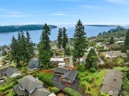 an aerial view of a house with garden space and ocean view