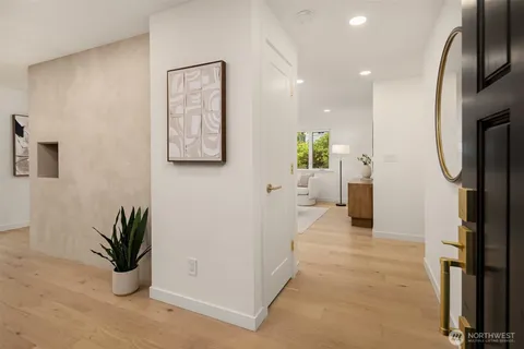 a view of hallway with wooden floor and a potted plant