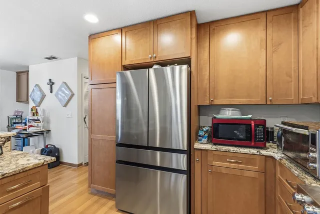 a kitchen with a refrigerator and a sink