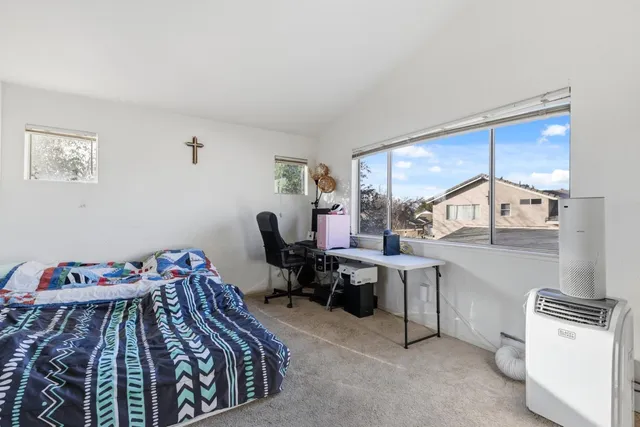 a bedroom with a workspace