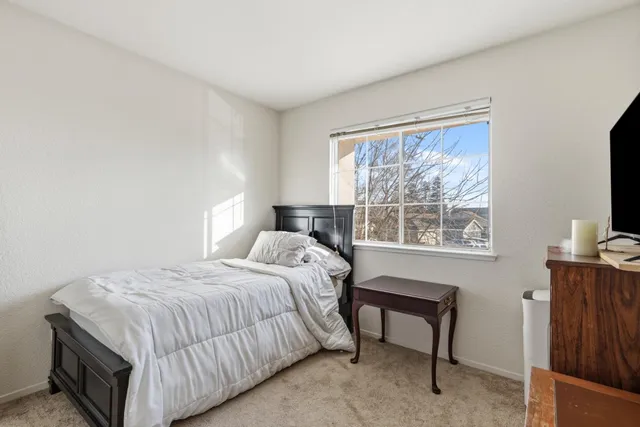 a bedroom with a bed and a window