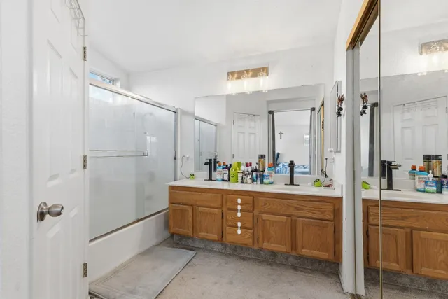 a bathroom with a tub sink a vanity and a mirror