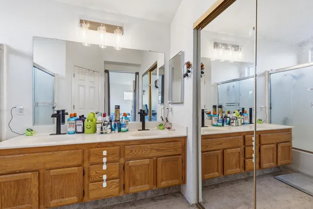 a bathroom with a double vanity sink mirror and double