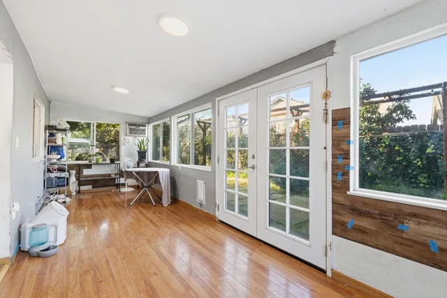 a view of workspace with wooden floor and windows