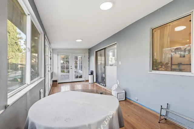 a room with pool table and windows