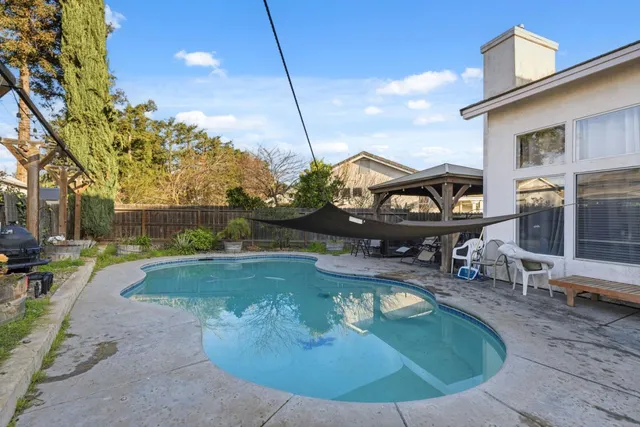a swimming pool with outdoor seating