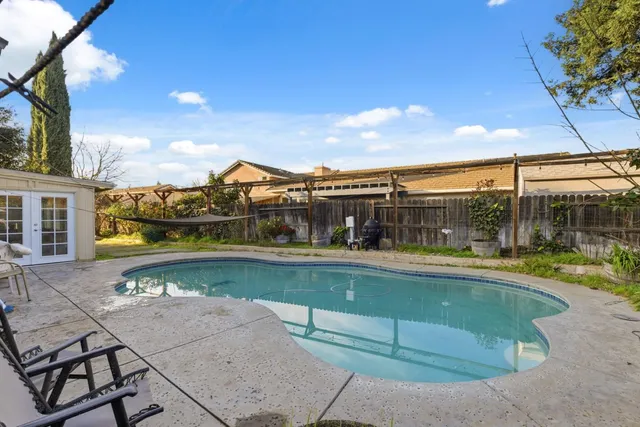 a view of a swimming pool with a yard
