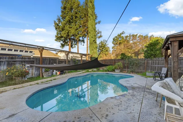 a view of a house with backyard and sitting area