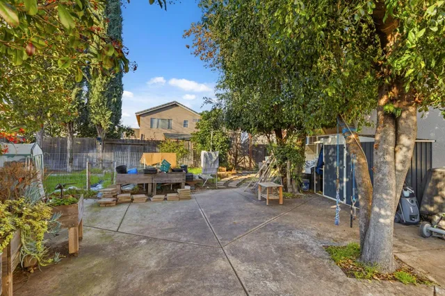 a view of a chairs and tables in the back yard of the house