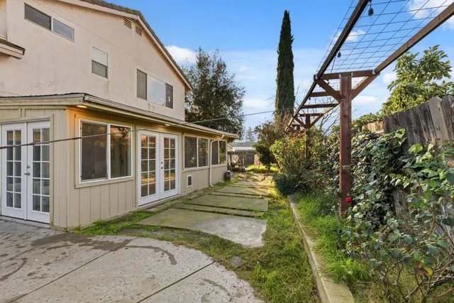 a view of a house with backyard and sitting area