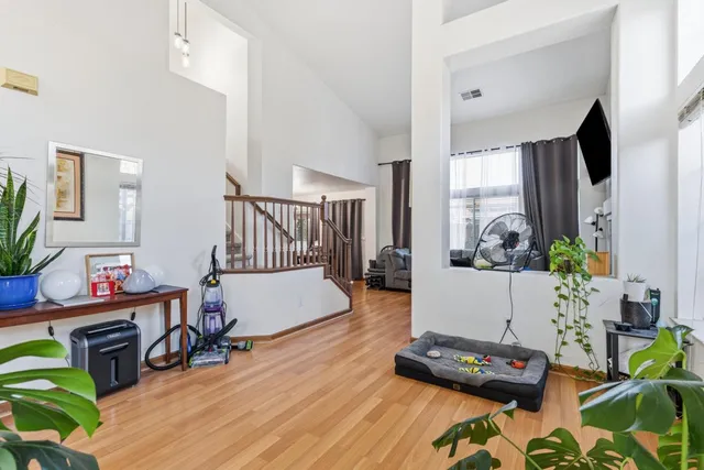 a living room with furniture and a wooden floor