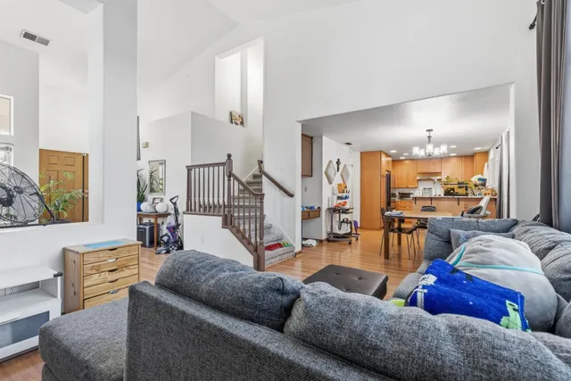 a living room with furniture and a chandelier