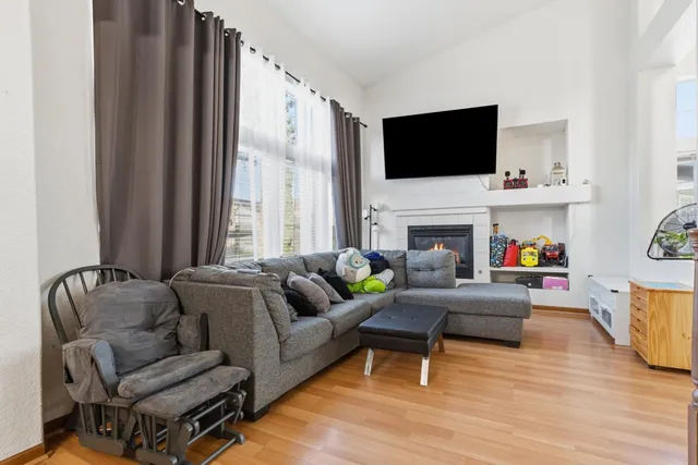 a living room with furniture fireplace and flat screen tv
