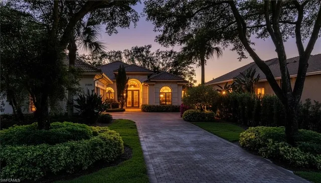 a view of a house with a large tree and a big yard