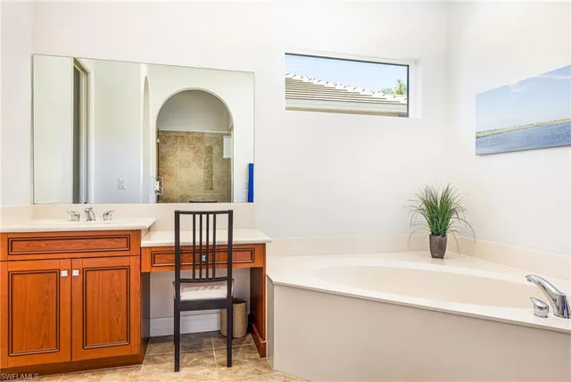 a bathroom with a sink a mirror and a bathtub