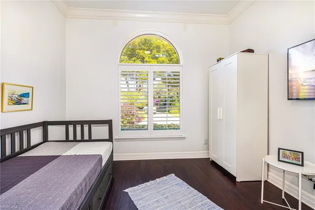 a view of hallway with a window and a wooden floor
