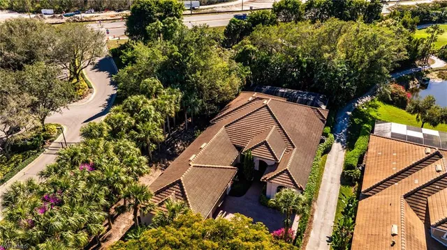 an aerial view of a house with swimming pool and garden