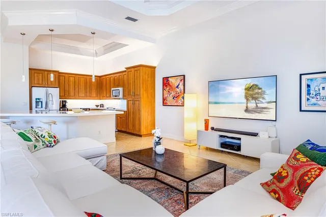 a living room with furniture and kitchen view