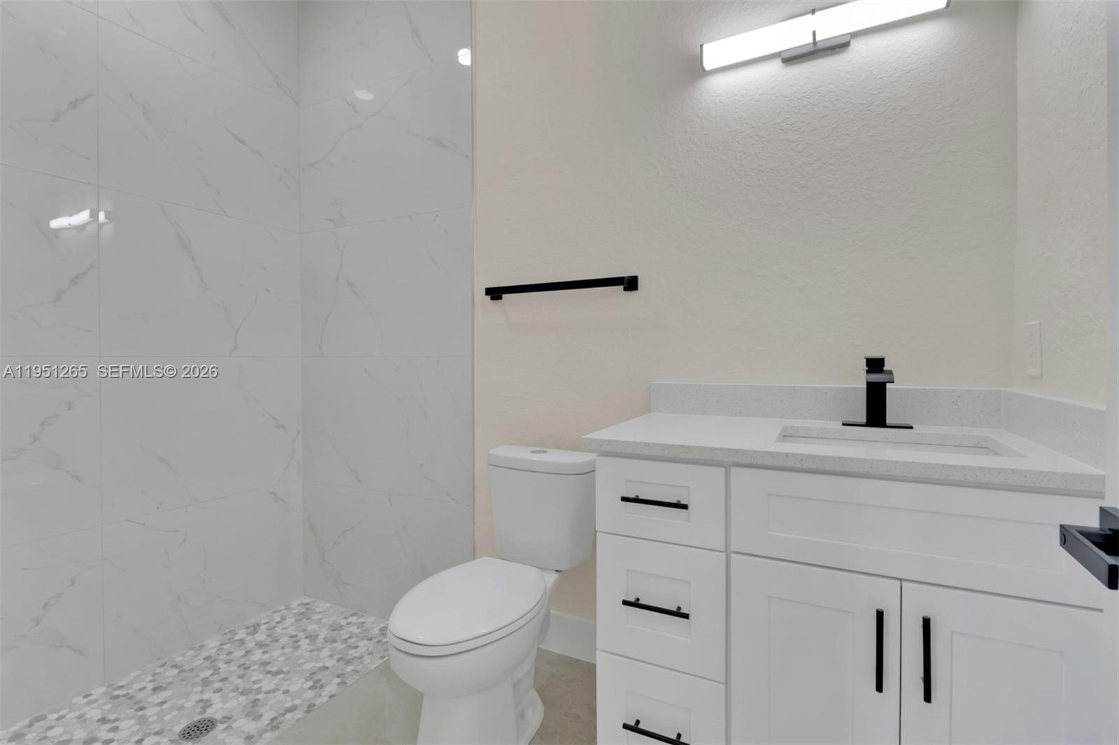 4501 15th Street Southwest, Unit 4501 Lehigh Acres, FL 33973 - Photo 12 of 40 a bathroom with a sink a toilet and shower