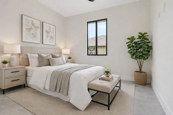 a bedroom with bed and a night stand