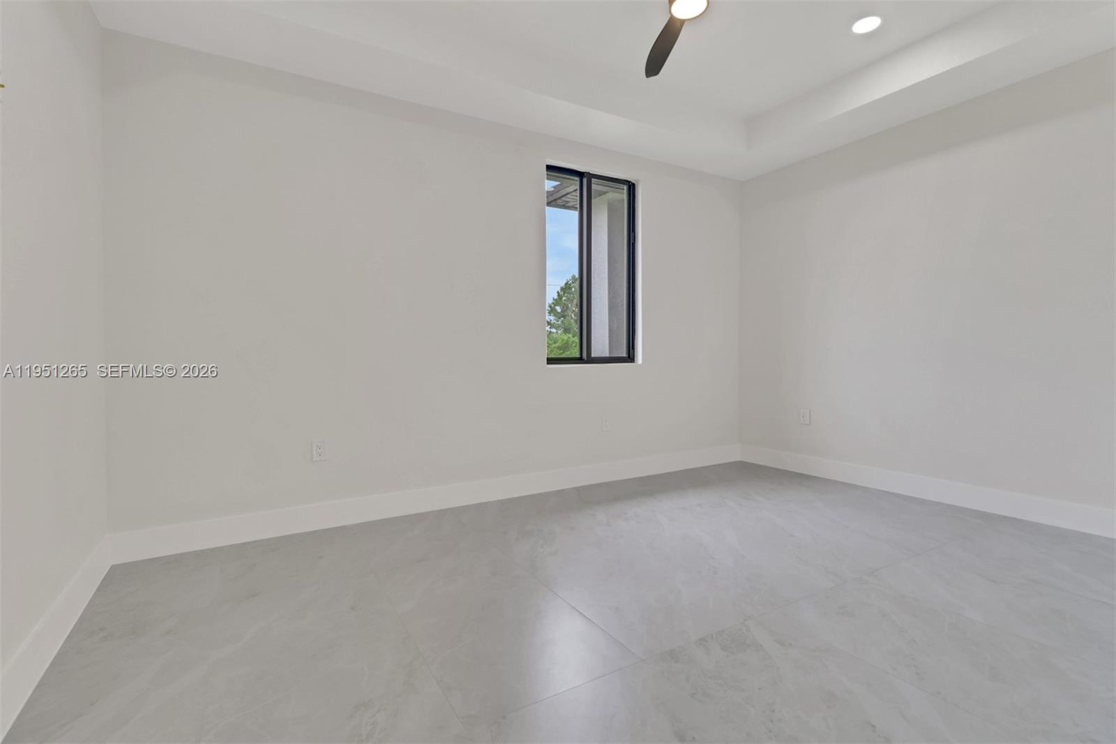 4501 15th Street Southwest, Unit 4501 Lehigh Acres, FL 33973 - Photo 17 of 40 an empty room with a window and ceiling fan