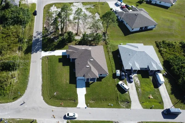 an aerial view of a house with a garden and trees