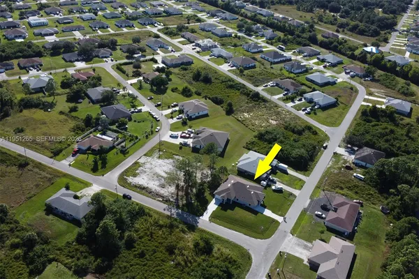an aerial view of multiple houses with yard