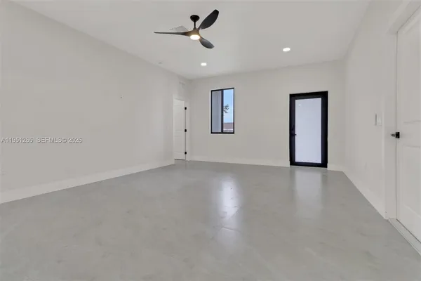 an empty room with a empty space and windows