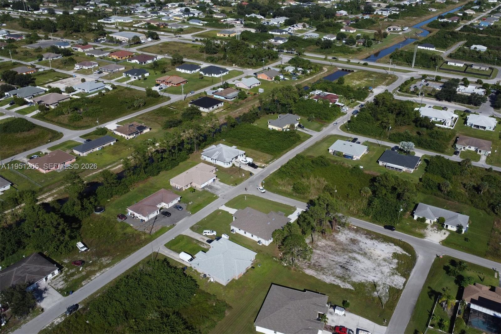 4501 15th Street Southwest, Unit 4501 Lehigh Acres, FL 33973 - Photo 35 of 40 an aerial view of residential houses with outdoor space