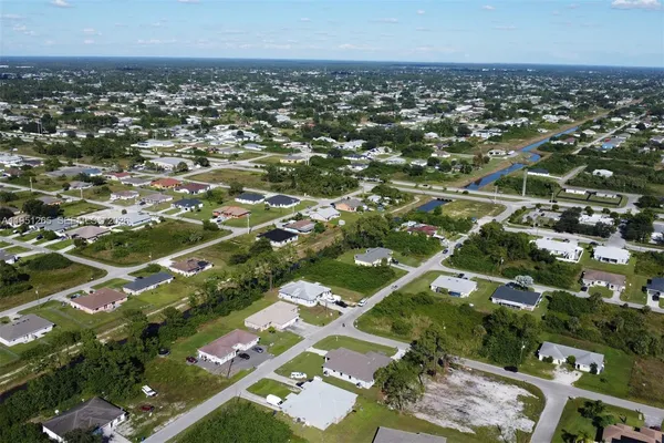 an aerial view of residential houses with city view