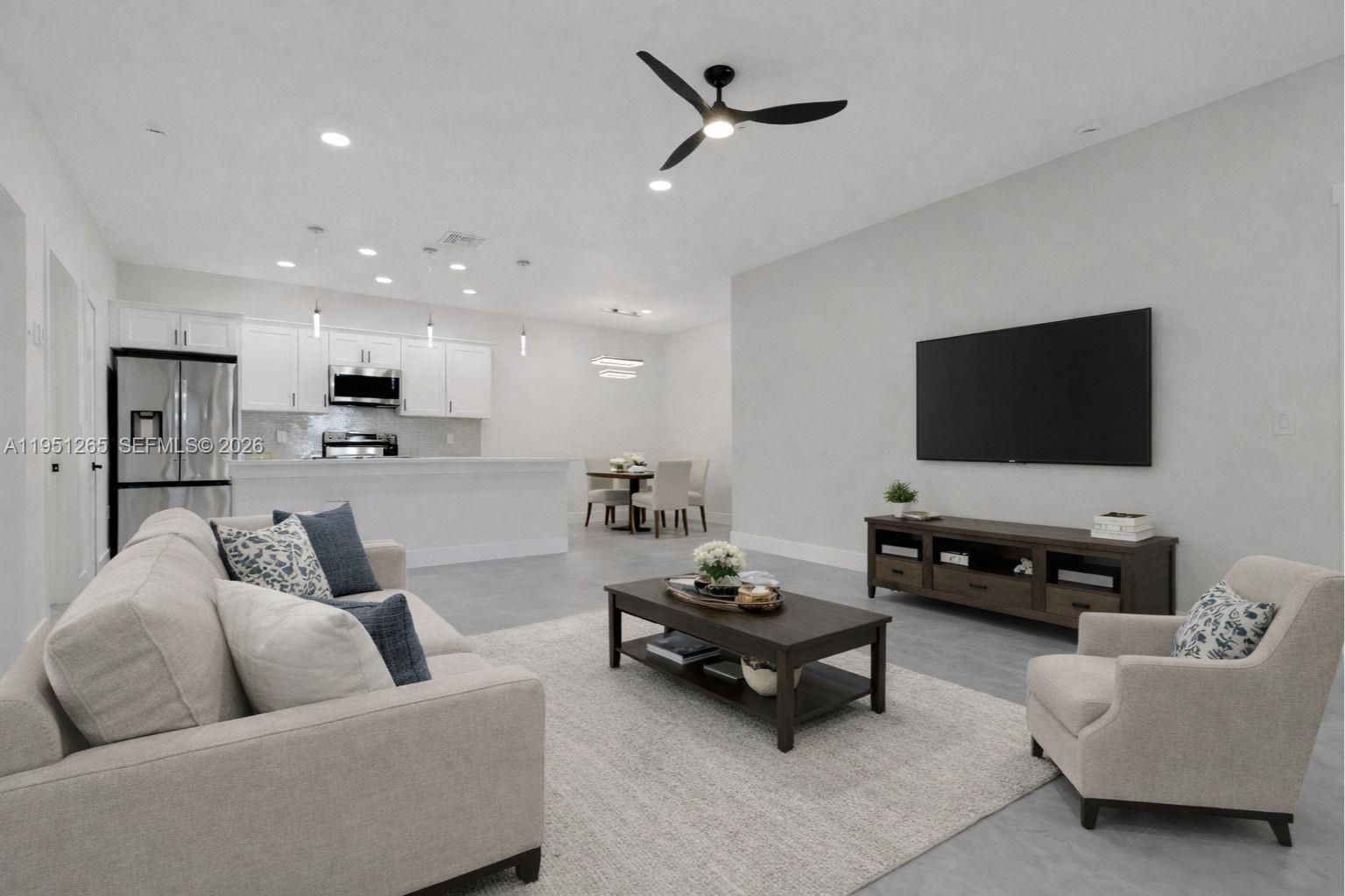 4501 15th Street Southwest, Unit 4501 Lehigh Acres, FL 33973 - Photo 4 of 40 a living room with furniture and a flat screen tv