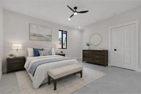 a spacious bedroom with a bed a dresser and a chandelier