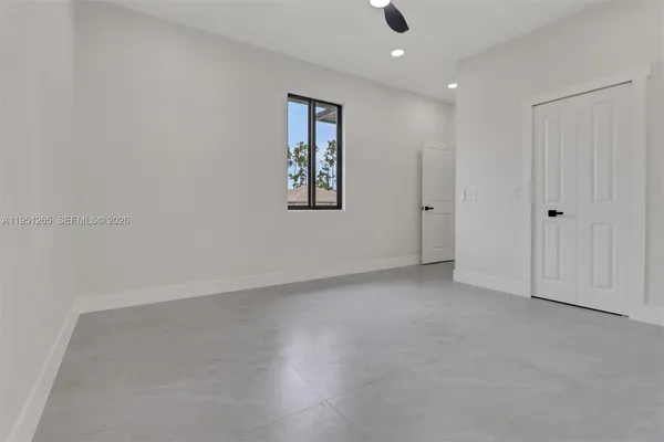 an empty room with a empty space and windows