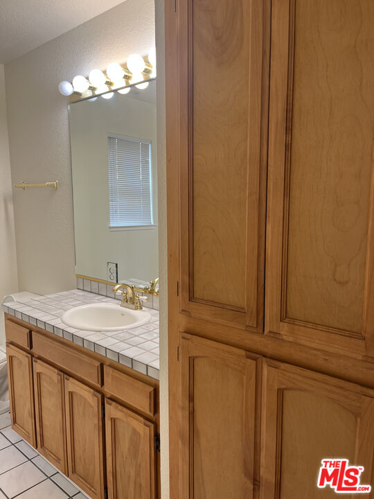 2308 Walnut Grove Avenue San Jose, CA 95128 - Photo 4 of 5 a bathroom with a sink and a mirror