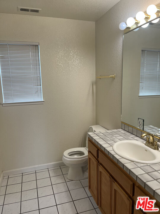 2308 Walnut Grove Avenue San Jose, CA 95128 - Photo 5 of 5 a bathroom with a granite countertop sink a toilet and a mirror