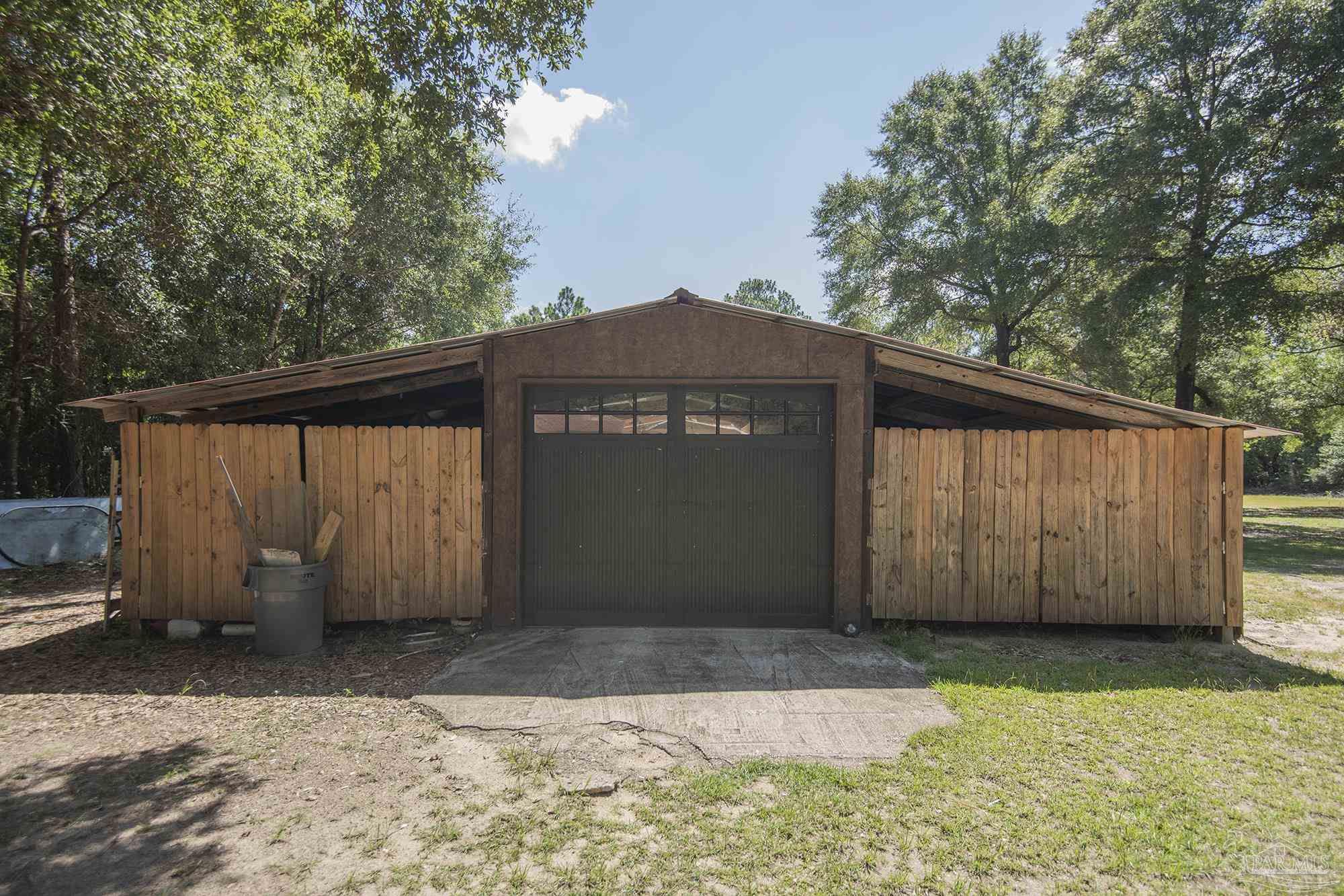 6739 Deception Road Milton, FL 32583 - Photo 13 of 24 a view of a house with a backyard
