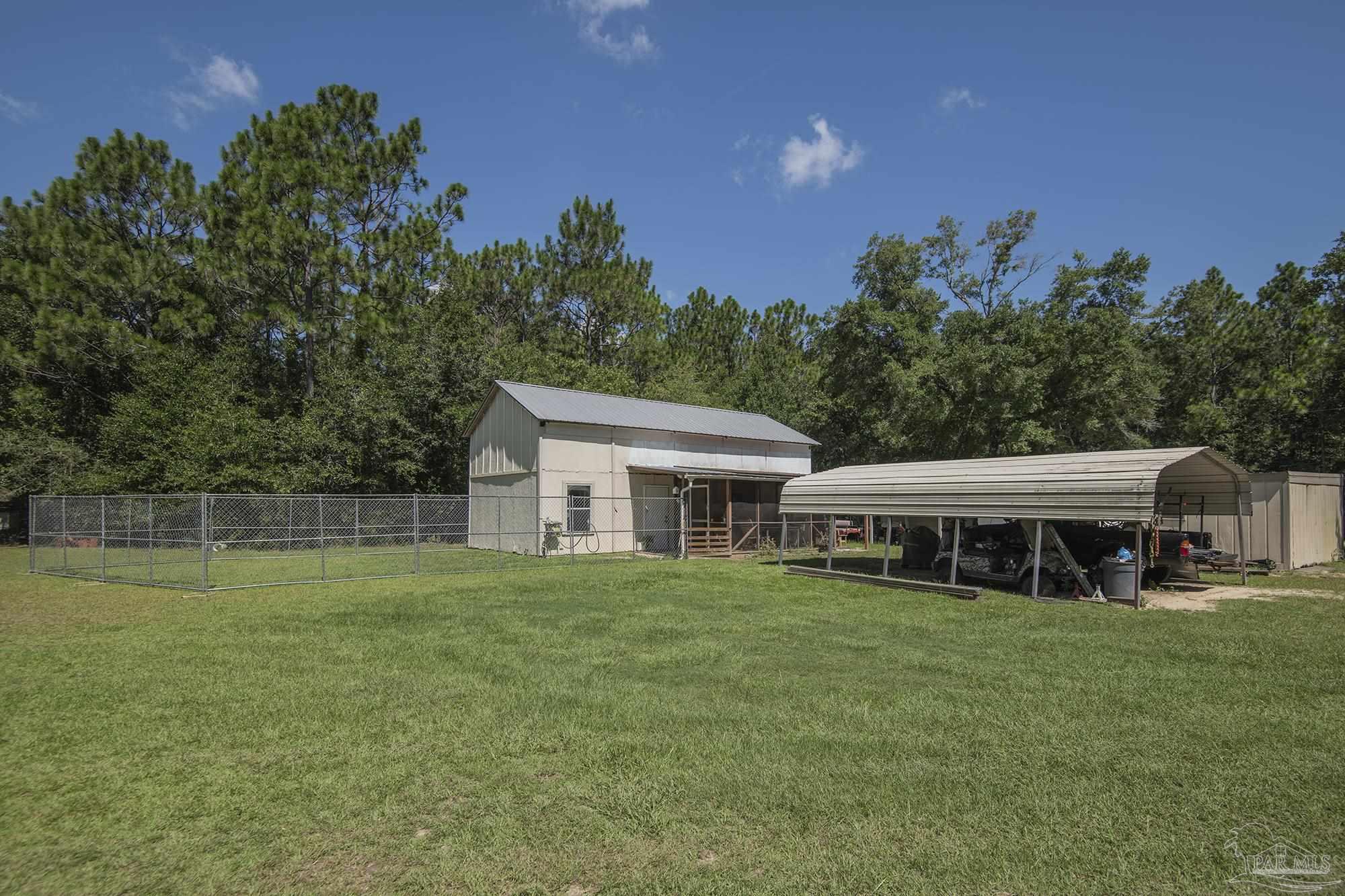6739 Deception Road Milton, FL 32583 - Photo 16 of 24 a view of a house with a yard and sitting area