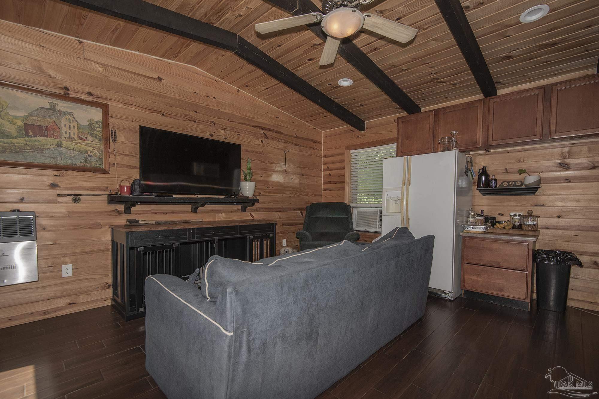 6739 Deception Road Milton, FL 32583 - Photo 17 of 24 a living room with furniture and a flat screen tv
