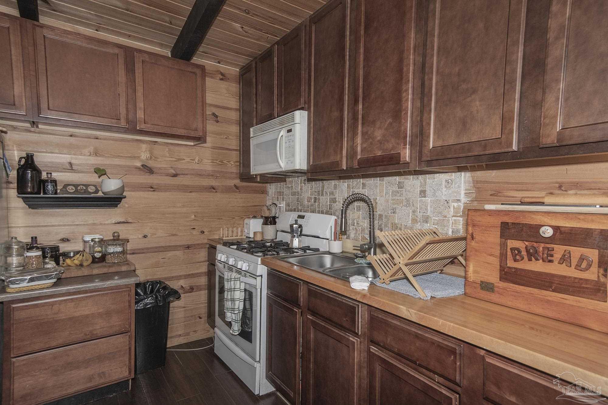 6739 Deception Road Milton, FL 32583 - Photo 20 of 24 a kitchen with stainless steel appliances granite countertop a sink a stove and cabinets