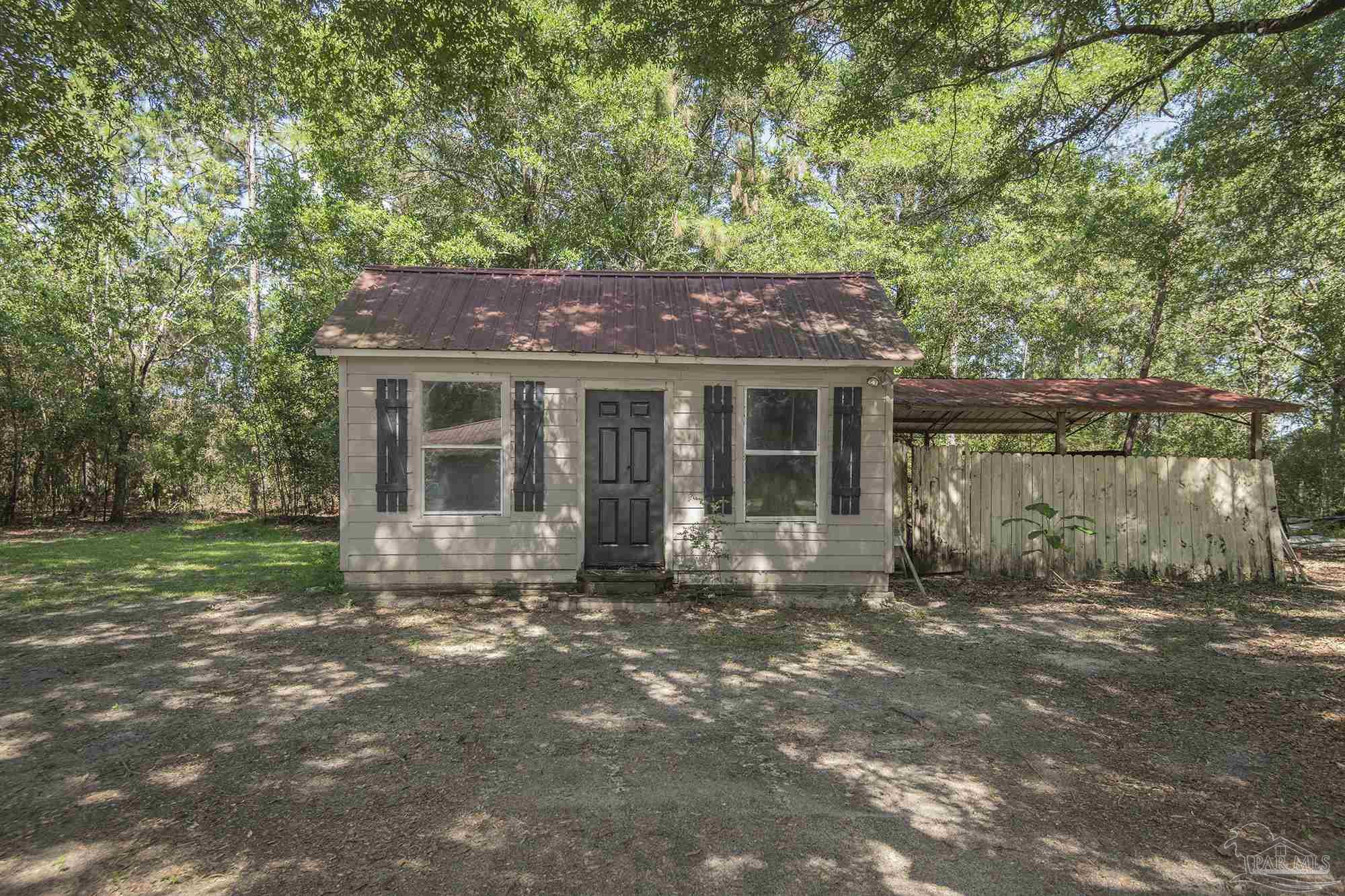 6739 Deception Road Milton, FL 32583 - Photo 2 of 24 a house view with a garden space