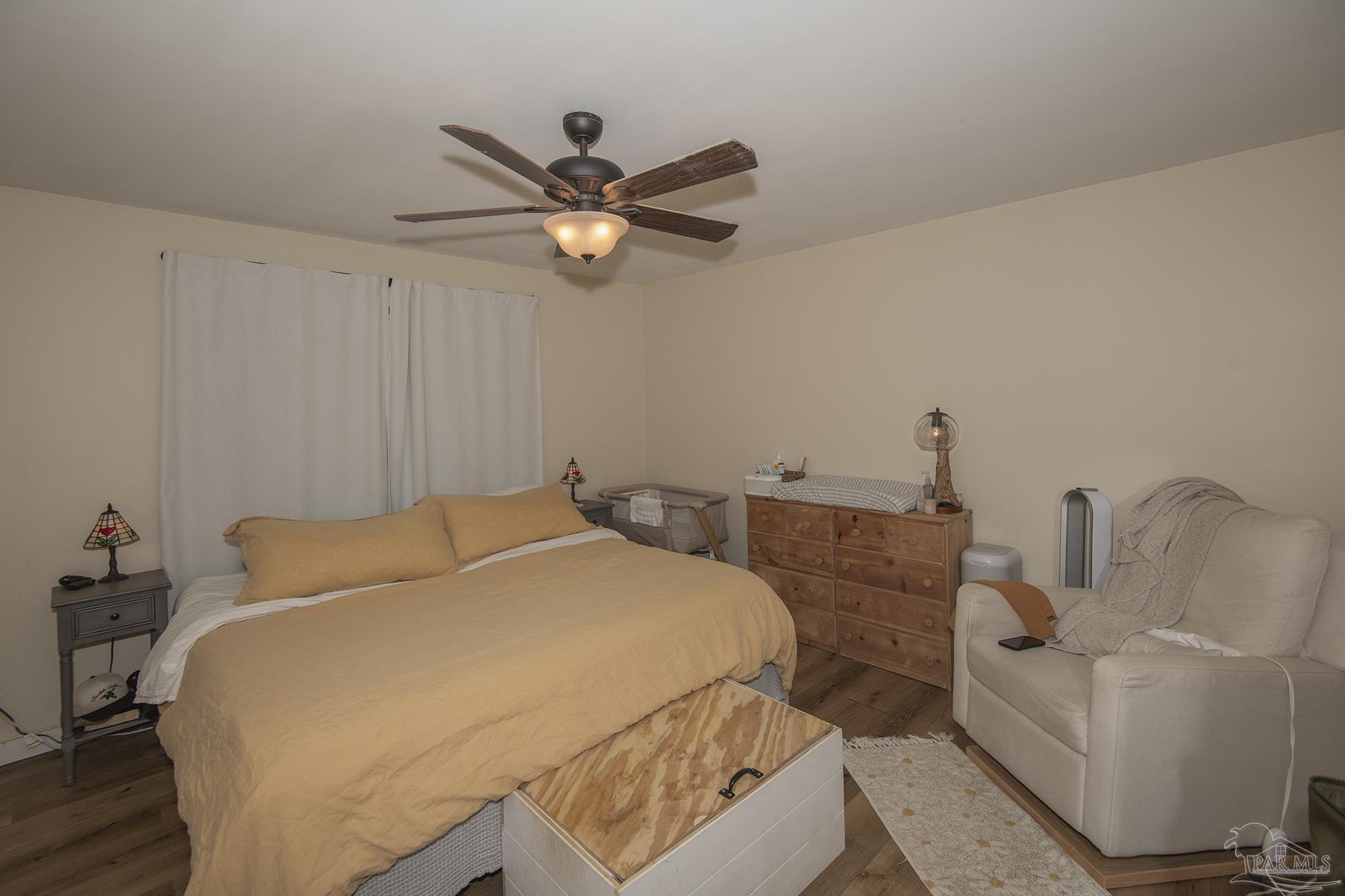 6739 Deception Road Milton, FL 32583 - Photo 21 of 24 a bedroom with a bed and a chandelier