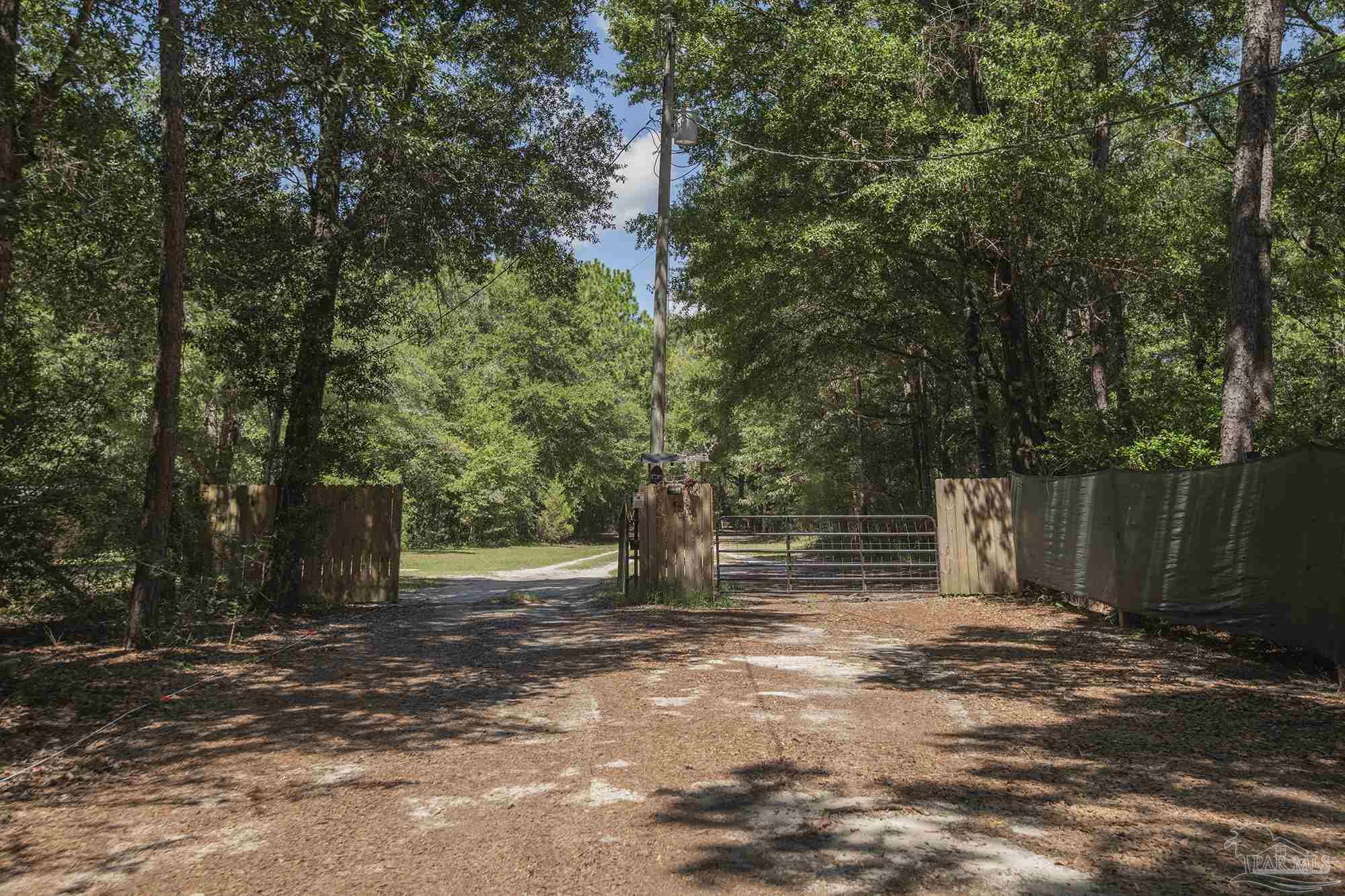 6739 Deception Road Milton, FL 32583 - Photo 24 of 24 a backyard of a house with lots of green space