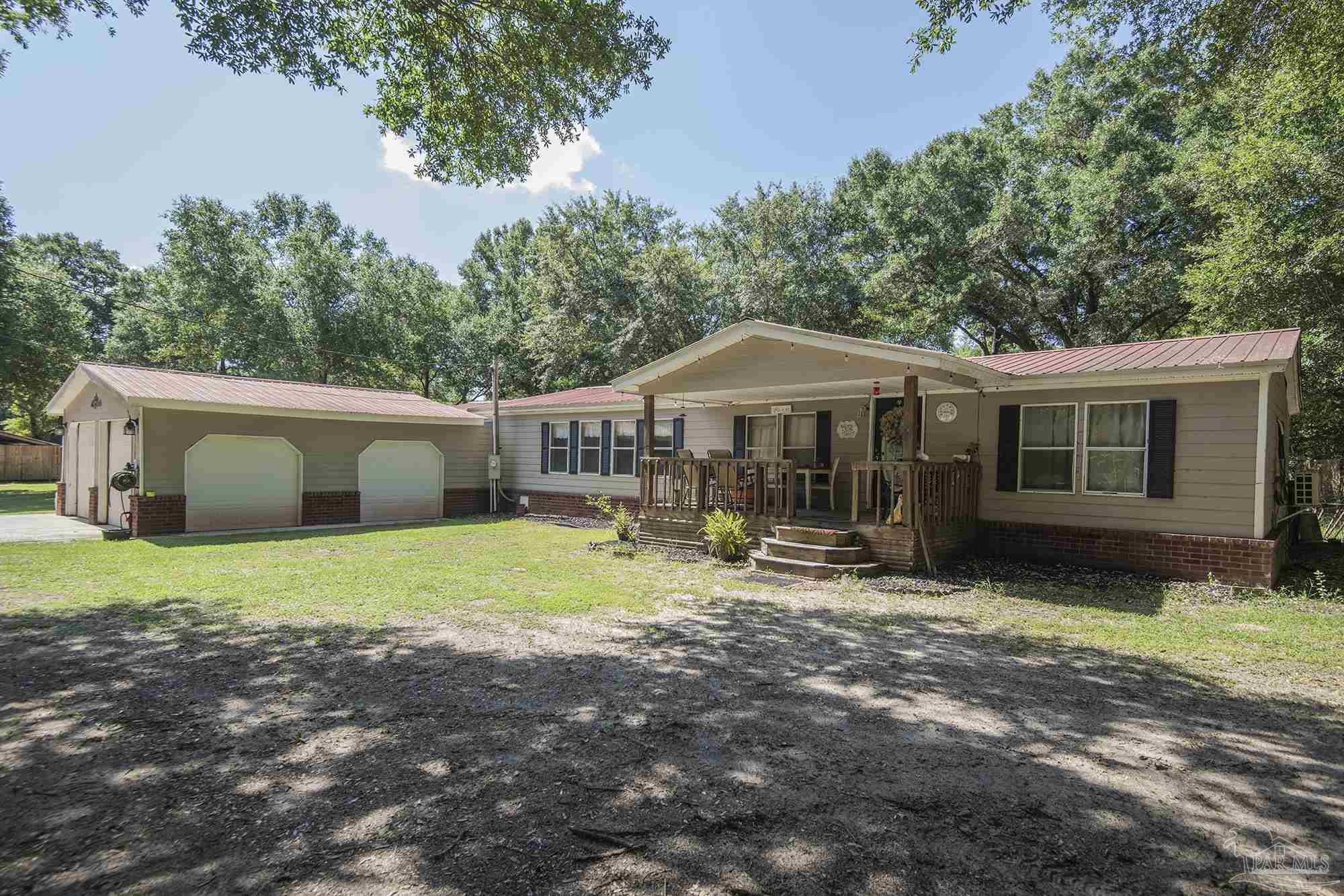 6739 Deception Road Milton, FL 32583 - Photo 3 of 24 a view of a house with backyard and sitting area