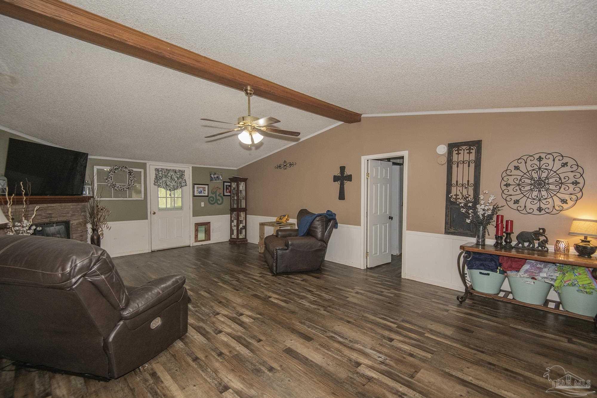 6739 Deception Road Milton, FL 32583 - Photo 7 of 24 a living room with furniture and a flat screen tv