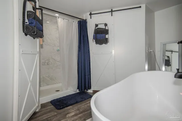 a bathroom with a shower and a sink
