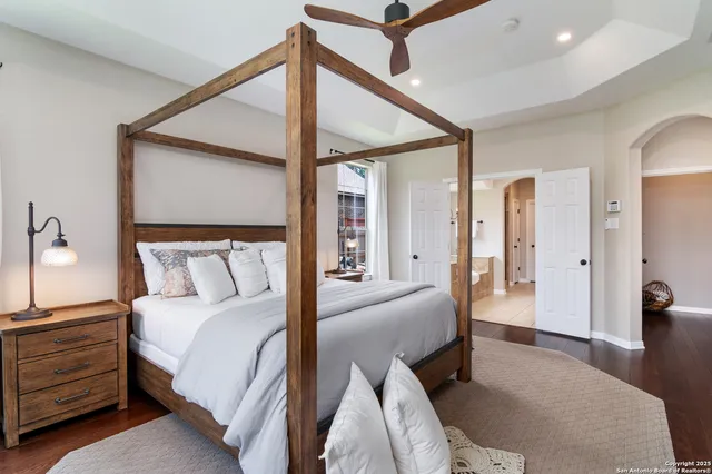 a spacious bedroom with a bed and a chandelier