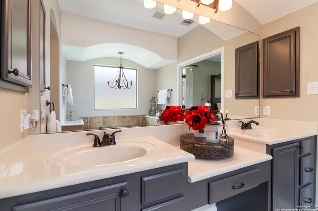 a bathroom with a sink double vanity and a mirror