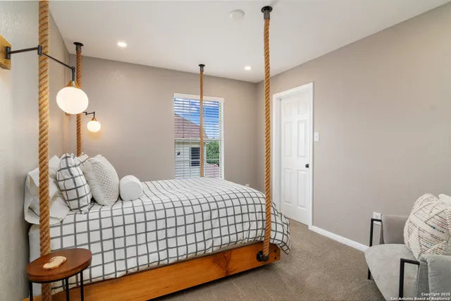 a bedroom with a bed and chandelier
